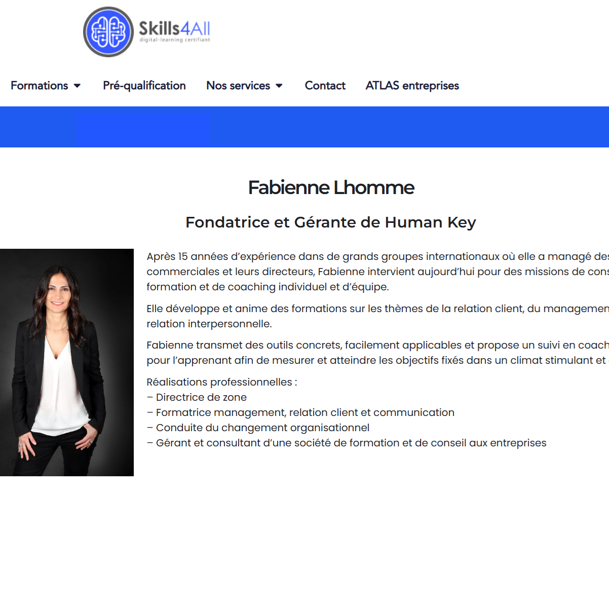 Portrait of Fabienne Lhomme, founder and Human Key consultant, in a black blazer and white blouse against a dark backdrop on a biography page